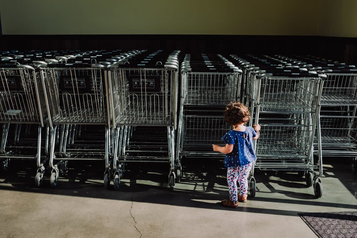 Child playing with grocery shopping carts